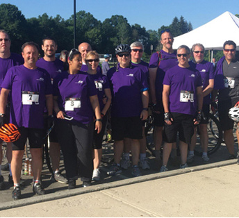 ADP associates wearing purple T-shirts at cycling event