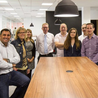 group of ADP associates standing around a conference table