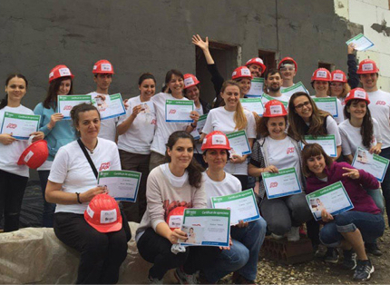 group of ADP associates wearing red hardhats and white T-shirts