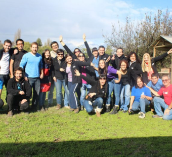 large group of ADP associates standing and waving