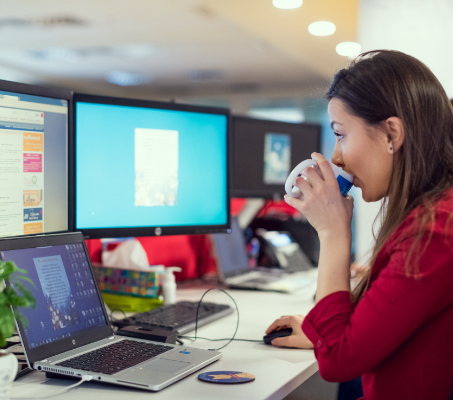 an ADP associate sipping a drink at her desk