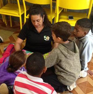 woman reading a story to a group of young children