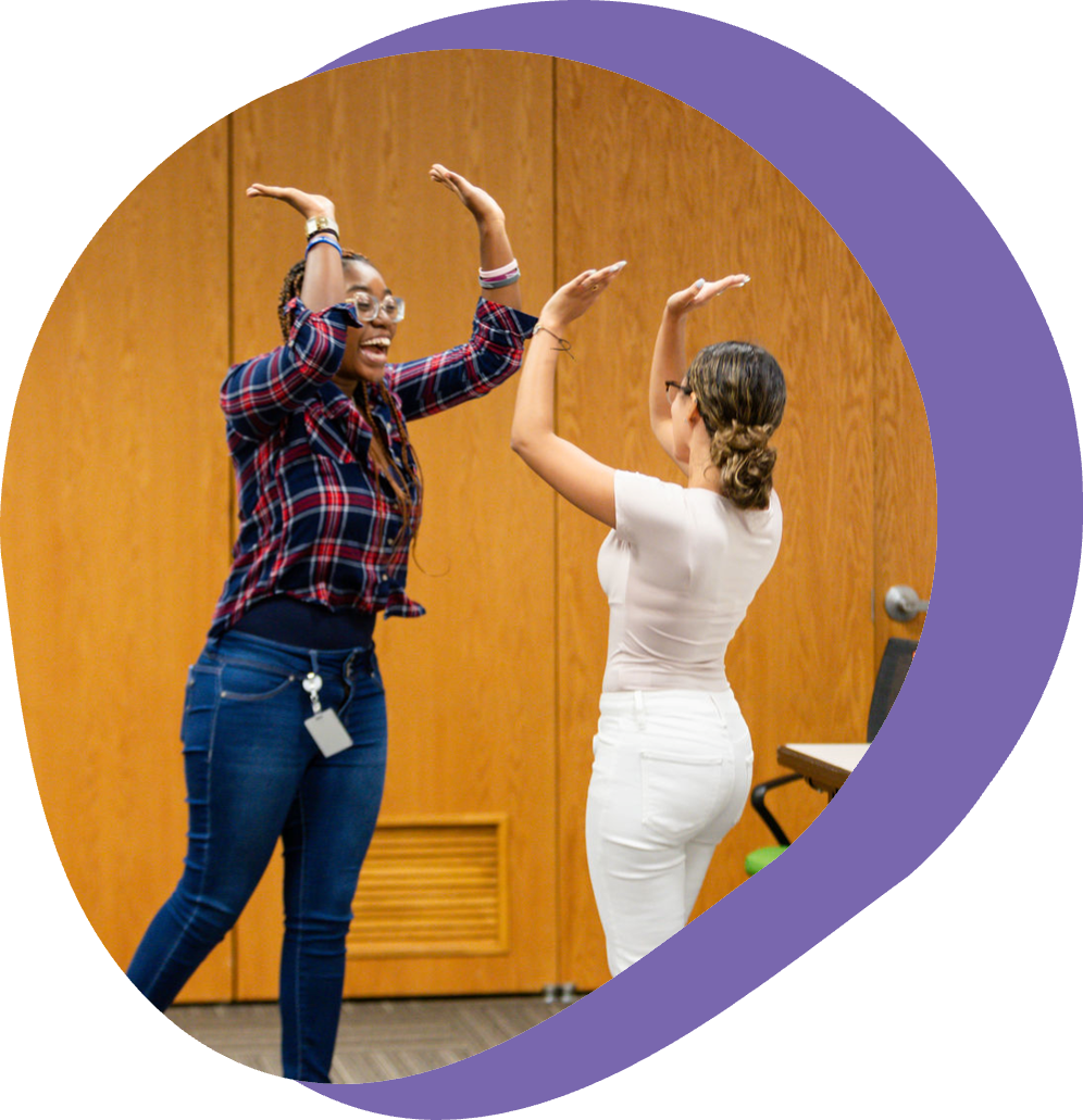 5_main-page two people high-fiving above their heads